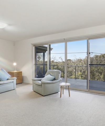 Spacious living area with panoramic views, ample natural light, and easy access to outdoor balcony space.