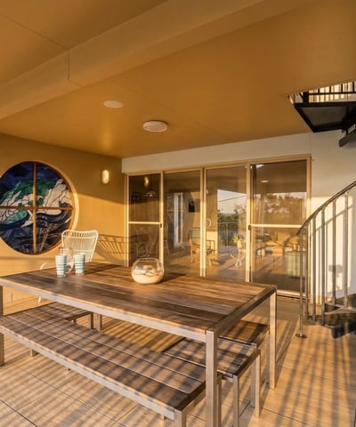Enjoy outdoor living on this spacious patio featuring a spiral staircase and captivating views.