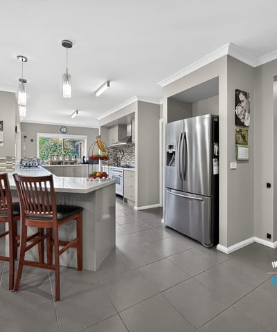 Modern kitchen with an open layout, featuring ample seating and contemporary appliances for everyday convenience.