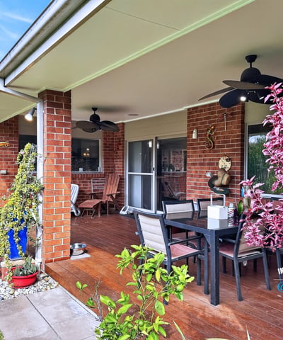 Spacious outdoor patio perfect for entertaining, surrounded by lush landscaping and easy access to indoor living.