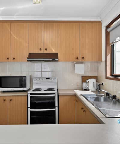 Bright kitchen features modern appliances and ample counter space, perfect for everyday cooking and entertaining.