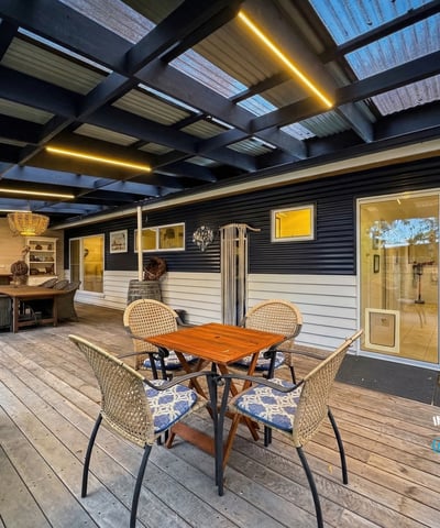 Inviting outdoor space featuring a covered patio and ample seating for leisure and entertainment.