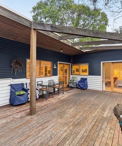 Contemporary home featuring a spacious outdoor deck, perfect for entertaining in a natural setting.