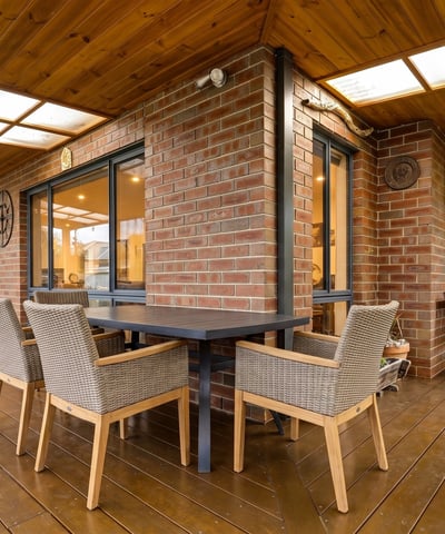 Spacious outdoor patio with dining area and built-in grill, perfect for entertaining and enjoying gatherings.