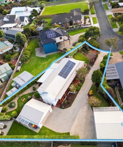 Spacious property featuring a large outdoor area and solar panels, nestled in a modern neighborhood.