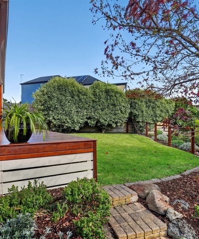 Inviting outdoor space with landscaped garden and seating area, perfect for relaxation and entertaining.