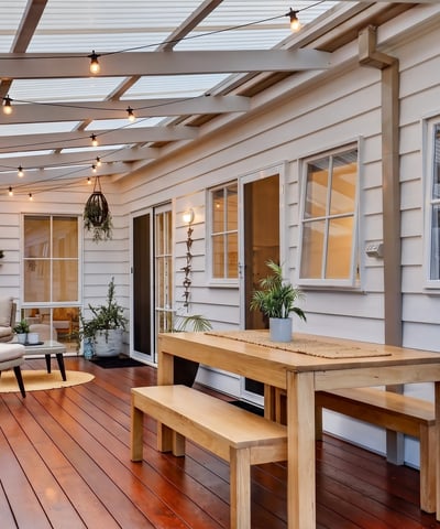 Bright, inviting outdoor space features a dining area and seating, perfect for entertaining year-round.