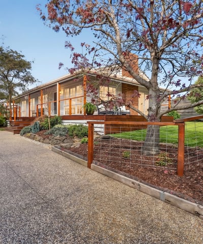 This welcoming home features spacious outdoor areas and a scenic driveway, perfect for family gatherings and relaxation.