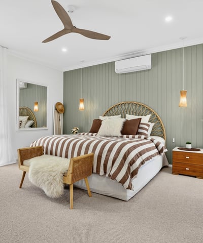 Bright and spacious bedroom featuring neutral tones, a comfortable bed, and inviting decor for relaxation.