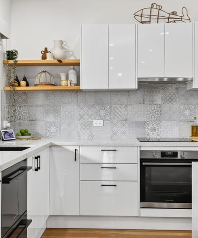 Modern kitchen featuring sleek cabinetry, advanced appliances, and eye-catching tile backsplash for a contemporary culinary experience.