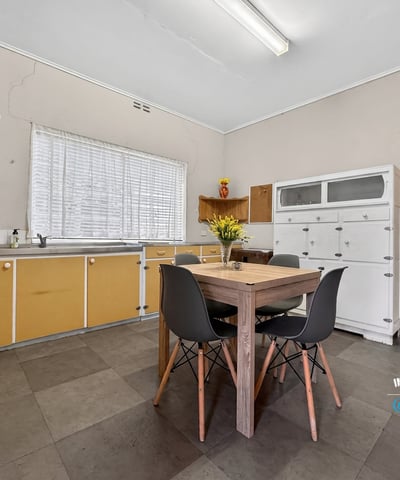Bright, functional kitchen featuring ample storage and a cozy dining area, perfect for everyday meals.