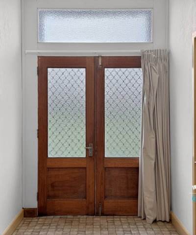 Bright entryway featuring distinctive glass doors and abundant natural light, welcoming you into the home.