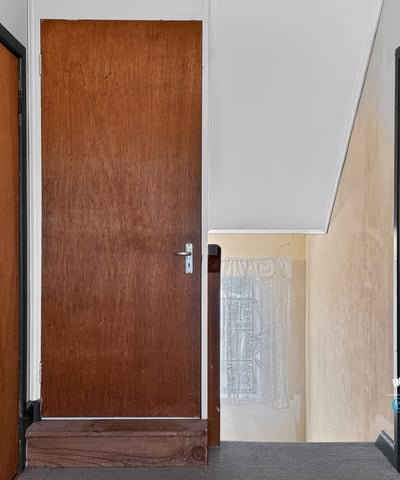 This inviting upper hallway features ample natural light and access to multiple rooms for convenience.
