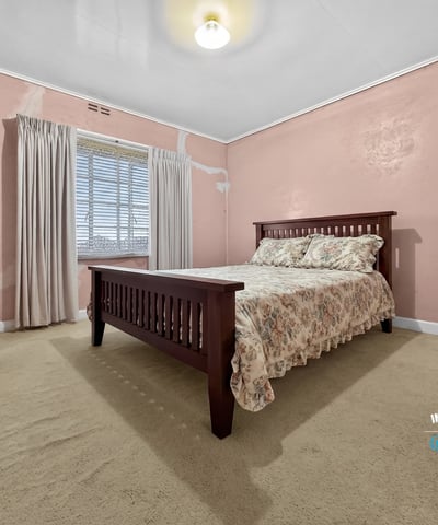 Spacious bedroom featuring natural light, ample storage, and unique wall textures ready for personalization.