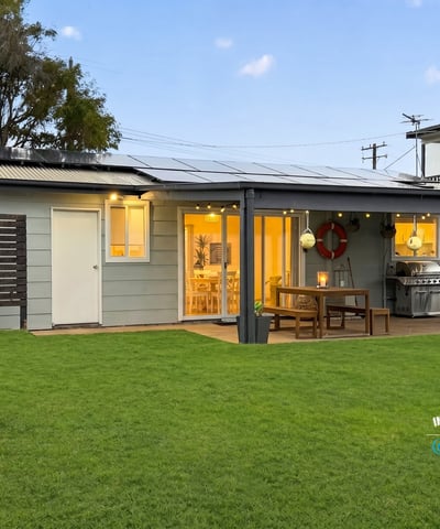 This modern home features a spacious yard, inviting patio area, and ample natural light throughout.