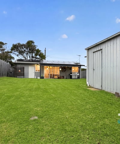 Spacious backyard perfect for outdoor activities, featuring a cozy home with modern amenities and ample storage.