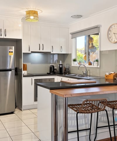 Modern kitchen featuring sleek cabinetry, stainless steel appliances, and a spacious breakfast bar perfect for entertaining.