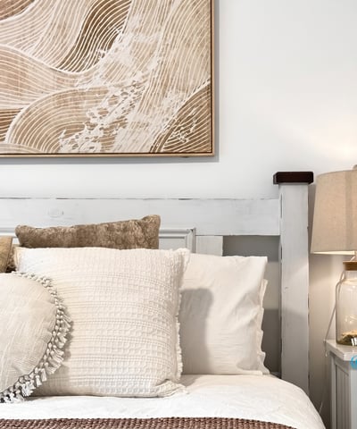 Bright and inviting bedroom featuring textured decor and warm, neutral tones for a cozy atmosphere.