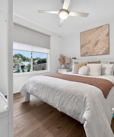 This inviting bedroom features a spacious layout, abundant natural light, and contemporary decor for comfortable living.