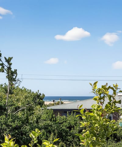 Enjoy stunning coastline views from this elevated property, surrounded by lush greenery and peaceful ambiance.