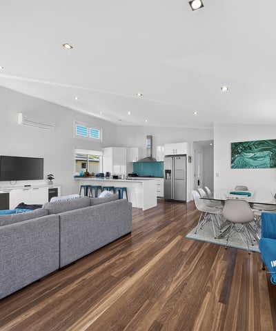 Modern open-concept living space with natural light, sleek design, and inviting atmosphere for family gatherings.