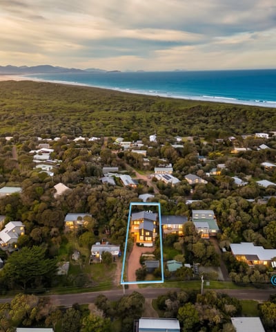 Discover a spacious home surrounded by lush landscapes, just a short stroll from beautiful coastal views.