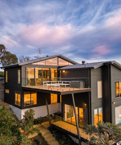 Contemporary home with expansive windows, offering breathtaking views and seamless integration with nature.