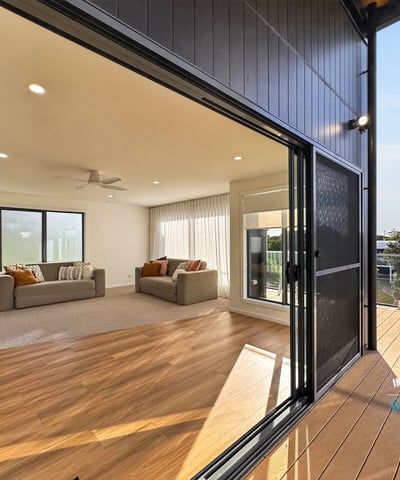 Bright, open living area seamlessly connects to an inviting outdoor deck, perfect for entertaining and relaxation.