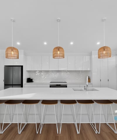 Bright and airy kitchen featuring modern finishes, ample counter space, and inviting seating for gatherings.