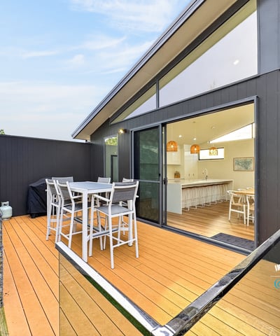 Spacious outdoor deck seamlessly connects to an airy indoor living space, perfect for entertaining and relaxation.