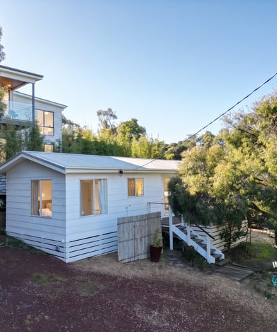 Cozy retreat nestled among lush greenery, offering a peaceful atmosphere and comfortable living space.
