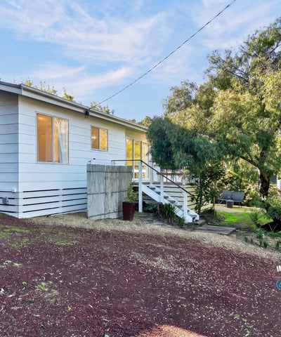 This inviting home features ample natural light, a spacious yard, and a peaceful setting near nature.