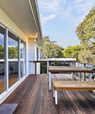 Enjoy outdoor living on this spacious deck, surrounded by lush greenery and natural beauty.