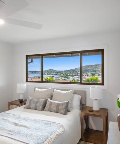 Bright bedroom featuring mountain views, modern decor, and large windows for ample natural light.