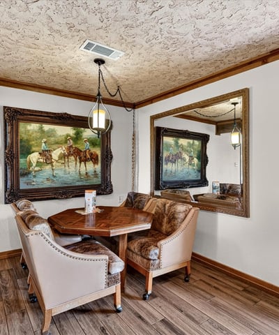Cozy dining nook features natural light, unique artwork, and a welcoming atmosphere for intimate gatherings.