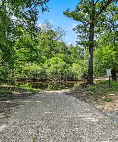 Private boat launch into Dorcheat Bayou, surrounded by lush greenery and tranquil views.