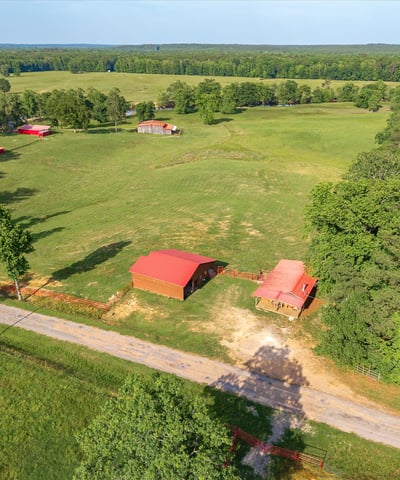 Spacious rural property featuring open fields, multiple outbuildings, and scenic views, perfect for your dream home.