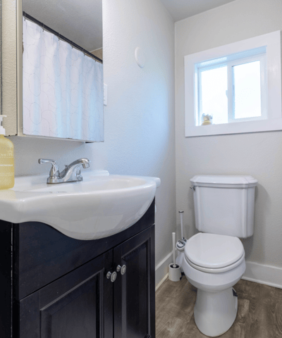 Modern bathroom featuring a sleek vanity, abundant natural light, and contemporary finishes for everyday convenience.