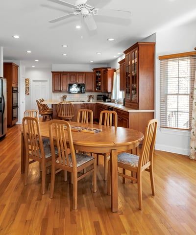 Kitchen dining area features a ceiling fan, French doors to the deck and patio, and morning sun and sunrise views.