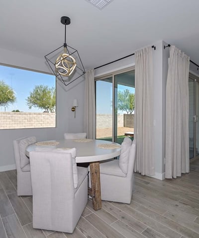 Tucked beside large windows and sliders, this intimate dining area invites sunlight and backyard views, perfect for morning meals or relaxed evenings.
