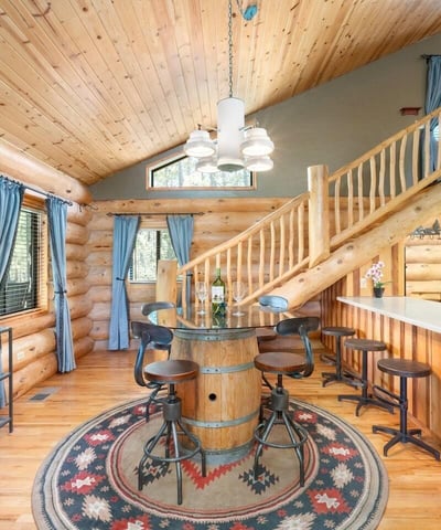 Bar seating area with solid counters and custom woodwork, connecting the kitchen to dining and living spaces for everyday use.