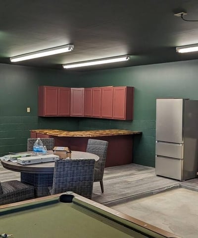 Versatile bonus room with built-in storage and durable finishes, ideal for recreation, hobbies, or gatherings. This adaptable space enhances everyday living in this Prescott log home.