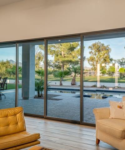 Sliding doors open to backyard views of the pool and golf course, filling the living area with light and Scottsdale charm.