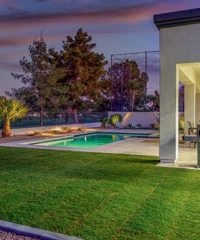 Backyard oasis with pool, lush lawn, and covered patio. A perfect Scottsdale retreat designed for relaxation and entertaining.