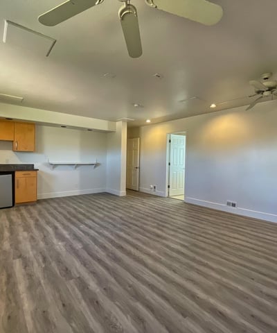 Entertainer s dream space with granite bar top, mini fridge, and modern cabinetry a perfect retreat for relaxation or guests.