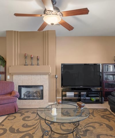 A perfect blend of spaciousness and comfort, this great room features abundant light, tile flooring, and neutral finishes ideal for both relaxation and entertaining.