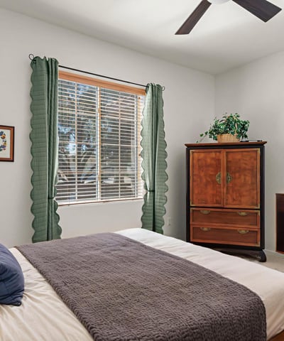 The guest room offers soft light, warm tones, and a peaceful feel ideal for guests or multi-purpose use.