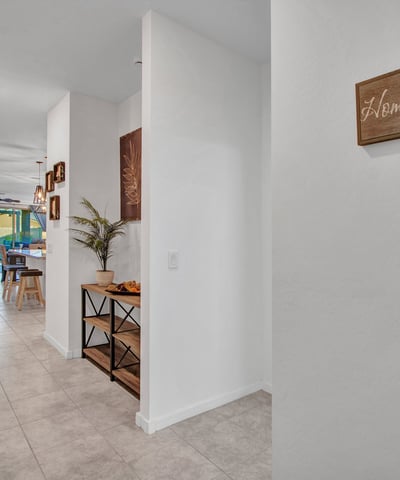 The spacious hallway showcases the home s open-concept flow, guiding you toward the living and kitchen areas. Updated finishes enhance comfort and style throughout this Litchfield Park home.