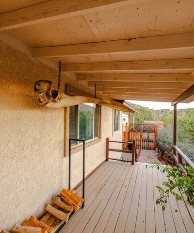 A charming porch lined with natural wood accents connects seamlessly to pathways and surrounding trees. Perfect for enjoying Hackberry s peaceful outdoor lifestyle.
