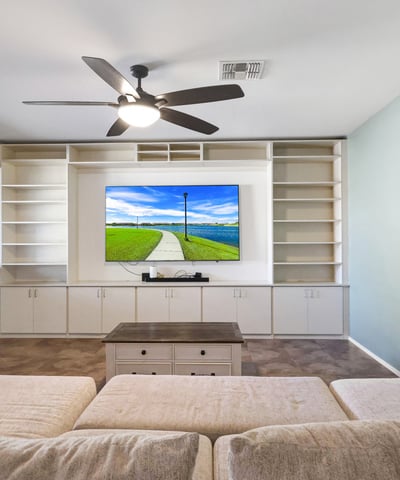 Open great room with tile floors and ceiling fan, seamlessly connecting the main living areas for comfortable daily living.
